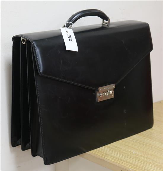 A black leather attaché case by Salvatore Ferragamo, with combination lock